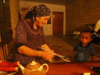 Dargi project: A Shiri woman is showing the plant book to her grandchild